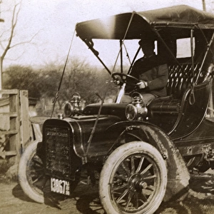 Man at the wheel of an early car, USA
