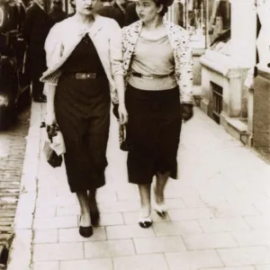 A pair of rich girls off shopping - passing an Etam Store