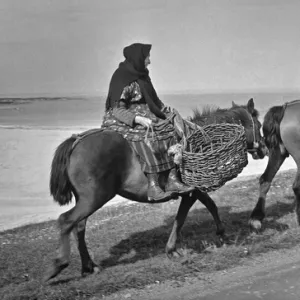 People on horseback, going to collect peat