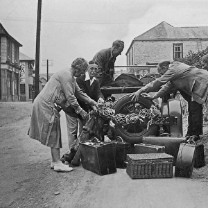 People loading a car at Perranporth, Cornwall