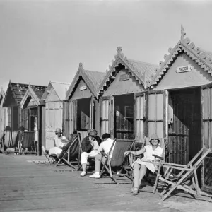 People outside beach huts, Cayeux, France