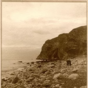 Two people on a rocky beach, North Wales
