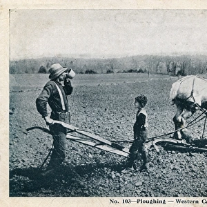 Ploughing in Western Canada - Farmer and son take a break