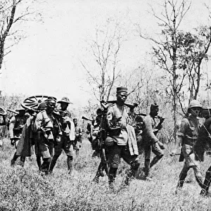 Porters carrying gun parts, East Africa, WW1