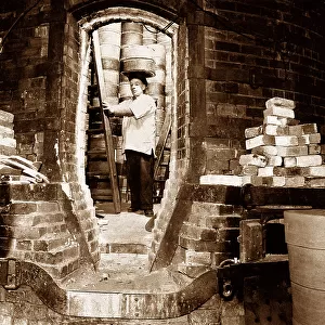 Pottery worker with a sagger, Potteries
