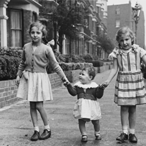 Three sisters walking down the street