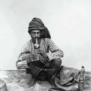 Snake charmer with snake, India