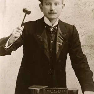 Tom Norman - Auctioneer, raising his gavel