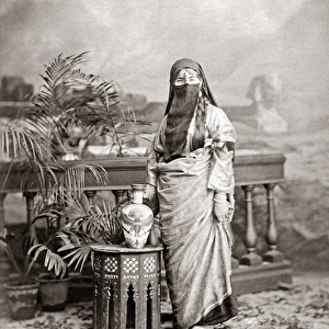 Veiled woman with ornate jug, Egypt, circa 1890