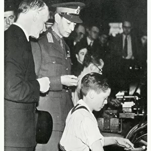 WW2 - Home Front - King George VI meets a young boy munition worker (15 year-old Leonard