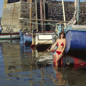 Young woman in bikini, Coverack, Cornwall