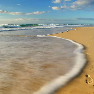 footprints in the sand - footprints in the sand are about to being washed away by an incoming wave. Nothing is forever - Fraser Island World Heritage Area, Great Sandy National Park, Queensland, Australia