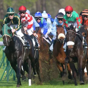 Riders and Racehorses galloping around racecourse