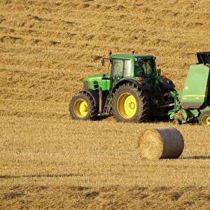 Tractor stopping to allow hay bale making machine to release bale of hay - September - Staffordshire - England