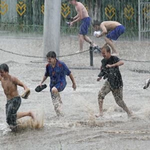 Teenagers playing in floodwaters