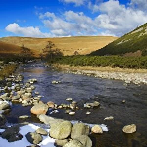 England, Northumberland, Northumberland National Park. A winter scene with the remains of snow on the river Breamish, running through the Cheviots and the Breamish valley near the village of Ingram situated within the Northumberland National Park