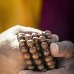 A Buddhist monk holds prayer beads (Japa Mala), Bodhnath, Nepal, Asia