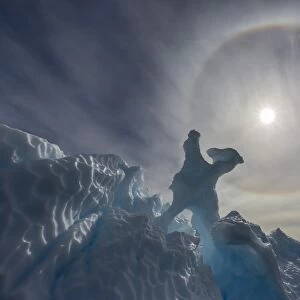 Complete sun halo and glacial iceberg detail at Cuverville Island, Antarctica, Polar