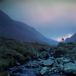 Cyclist on mountain bike, Honister Pass, The Lake District, Cumbria, England