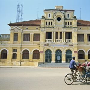 A cyclo passing the Old Post Office in Phnom Penh in Cambodia, Indochina