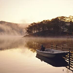 Early morning mist and boat, Derwent Water, Lake District, Cumbria, England