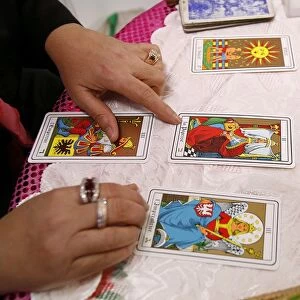 Fortuneteller laying cards on the table during a divination, Paris, France, Europe