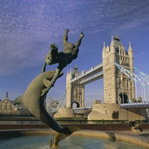 Fountain of child with dolphin and Tower Bridge, London, England, UK, Europe