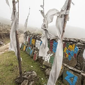Gateway to Nepal with flags and Buddhist inscriptions near the village of Tumling