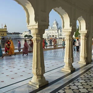 Group of Sikh women pilgrims walking around holy pool