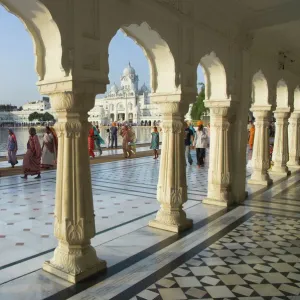 Group of Sikh women pilgrims walking around holy pool