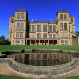 Hardwick Hall, near Chesterfield, reflected in pond under a clear blue sky, Derbyshire