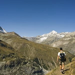 Hiker walking on trail near the Matterhorn