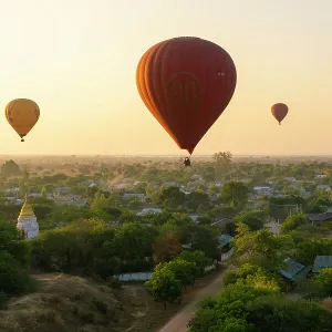 Hot-air balloons at sunrise over village near Bagan (Pagan), Myanmar (Burma), Asia