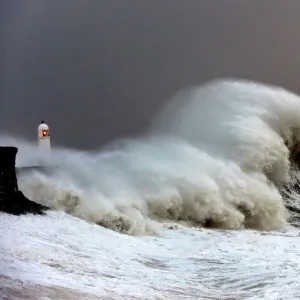 Huge waves crash against the harbour wall at Porthcawl, Bridgend, Wales, United Kingdom