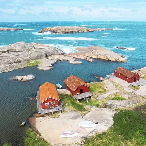Lonely wooden red cottages on a rocky coast, Bohuslan, Vastra Gotaland, West Sweden, Scandinavia, Europe