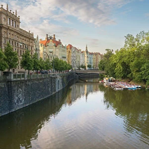 National Theatre and art nouveau buildings along Vltava River and boats at Slovansky island, Prague, Czech Republic (Czechia), Europe