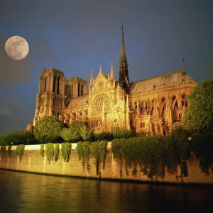 Notre Dame Cathedral at night, with moon rising above, Paris, France, Europe