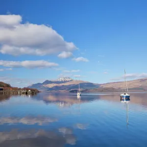 Picturesque tranquil Loch Lomond with sailing boats, Luss Jetty, Luss, Argyll and Bute