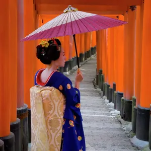 Portrait of a geisha holding an ornate umbrella at