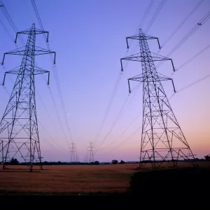 Pylons in a rural landscape at dusk