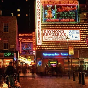 The Raymond Revuebar with neon signs in red light area at night, Soho, London