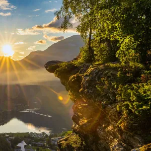 Last rays of sunset over Geiranger village and Geirangerfjord, UNESCO World Heritage Site