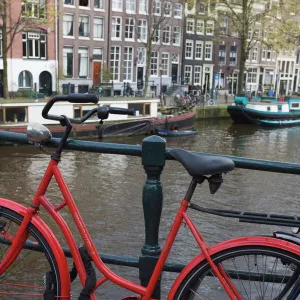 Red bicycle by the Herengracht canal, Amsterdam, Netherlands, Europe