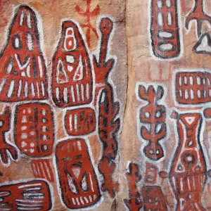 Sacred rock paintings on cliff depicting Dogon customs and stories in Songo