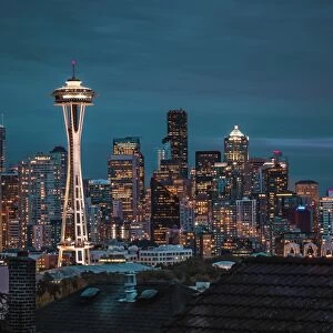 Seattle city skyline at night with urban office buildings and Space Needle viewed