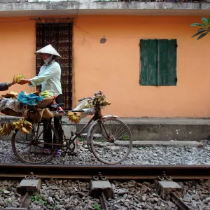 Selling bananas by the railway tracks in central Hanoi