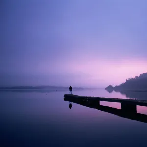 Setting sun through rising mist, Bassenthwaite Lake, Lake District, Cumbria