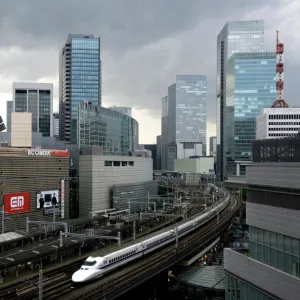 Shinkansen bullet train weaving through maze of buildings in the Yurakucho district of downtown Tokyo