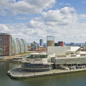 View across the Lowry Centre, apartments and new building construction work at Salford Quays Pier 8