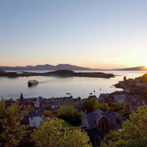 View over Oban Bay from McCaigs Tower, sunset, ferry coming into port, Oban, Argyll and Bute, Scotland, United Kingdom, Europe